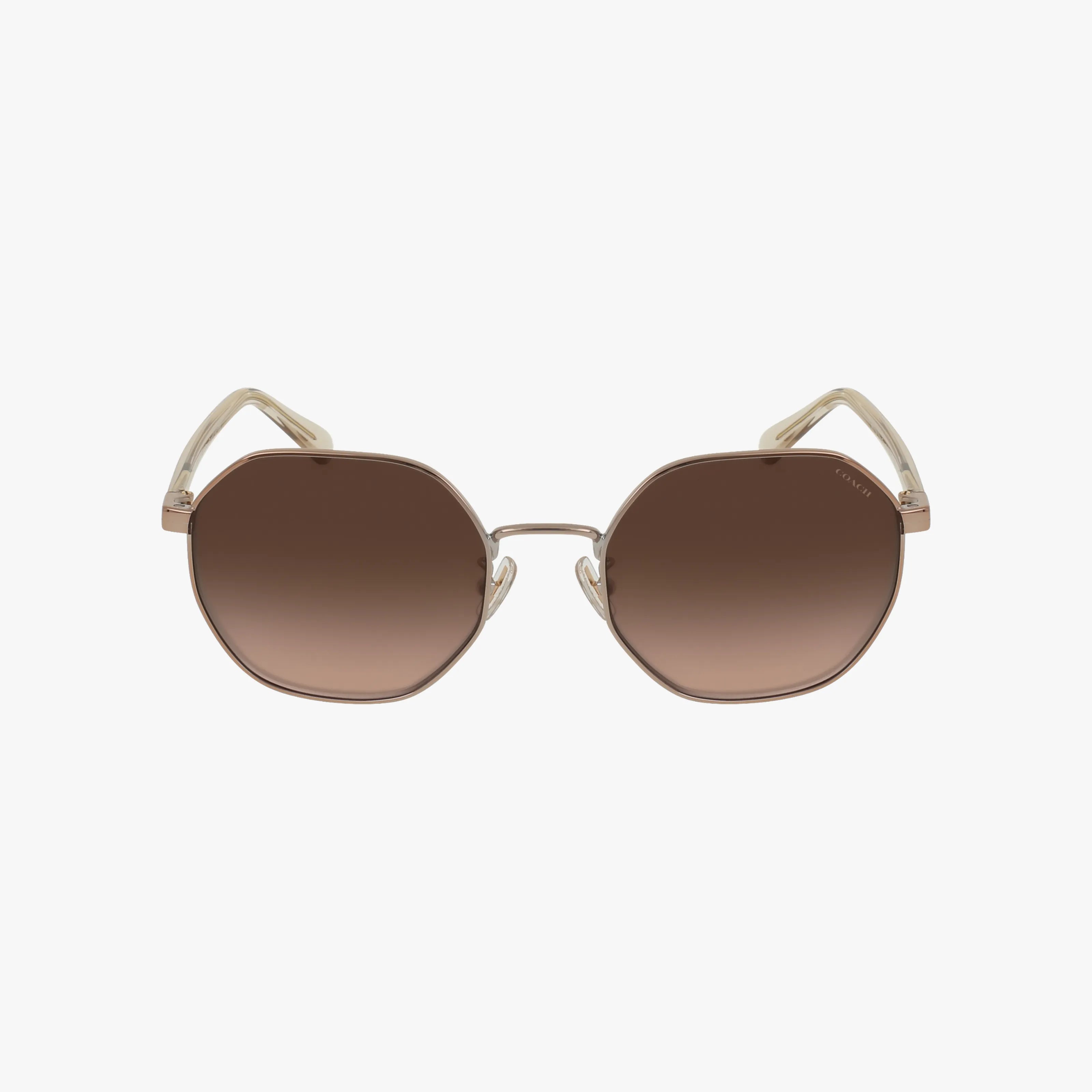 Front view of Coach HC7147 oversized geometric sunglasses with gold metal frames and brown gradient lenses shown against a white background.