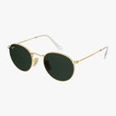 The Ray-Ban RB3447 ROUND features gold frames, round dark green lenses, and white-tipped arms for a chic bohemian style, showcased on a white background.