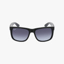 Front view of Ray-Ban RB4165 JUSTIN sunglasses with a durable black frame and dark gradient lenses, featuring a subtle logo on the upper left lens, displayed against a plain white background.