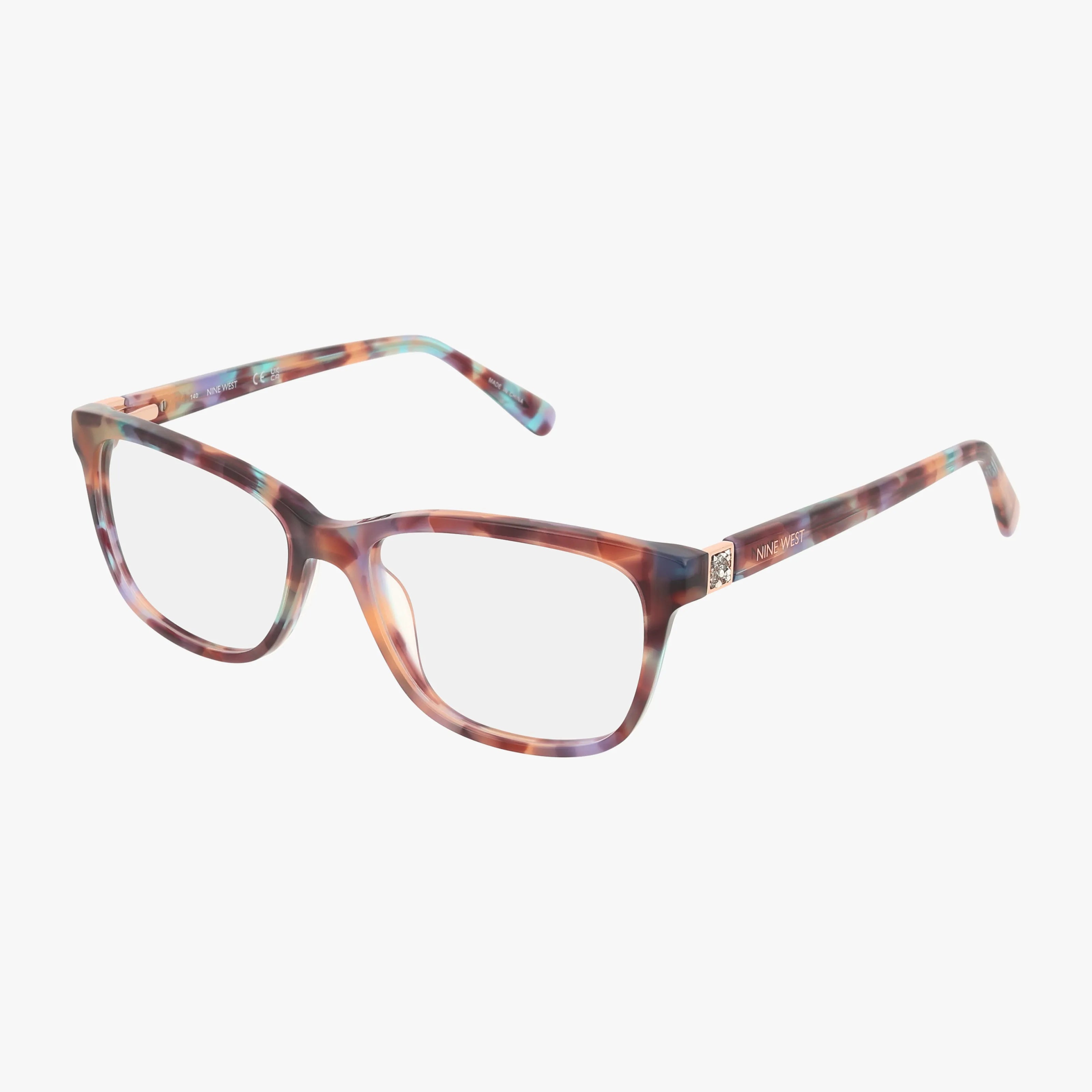 Nine West NW5214 eyeglasses feature rectangular frames in a marbled pink, purple, and blue pattern with subtle crystal accents, shown on a white background.