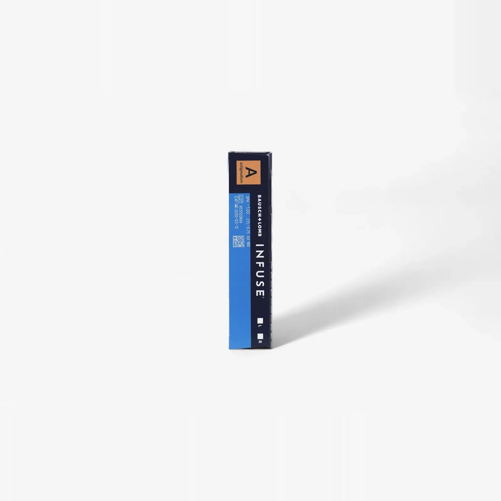 A rectangular blue and black box labeled Infuse B+L Infuse For Astig - 90Pk stands upright on a white surface, casting a faint shadow. The packaging for these one-day lenses has minimal text and features a small orange triangle at the top.