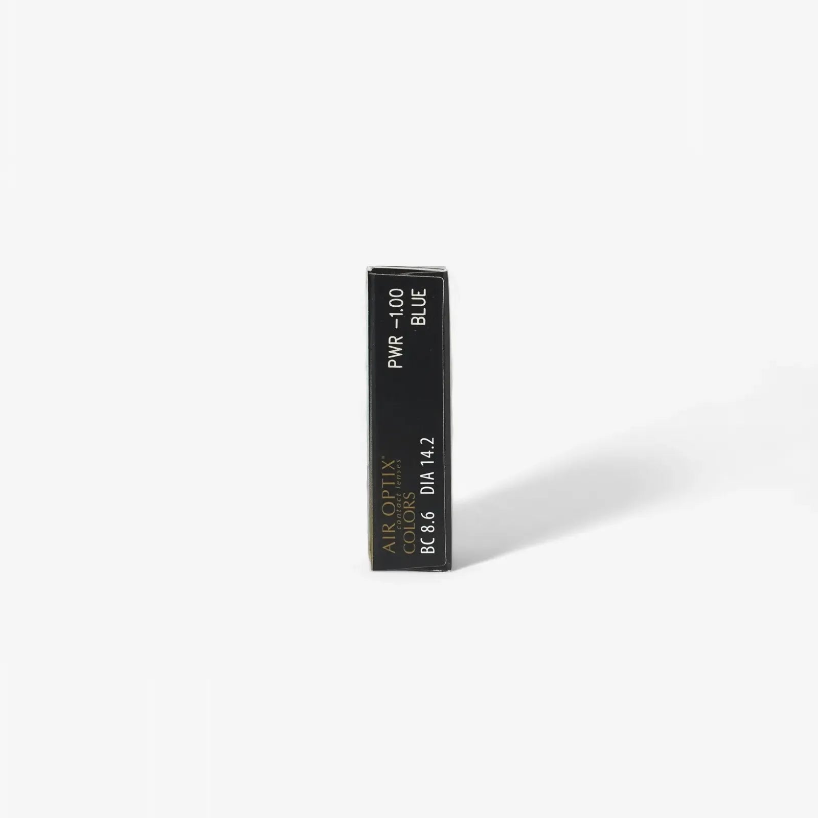 A rectangular black box labeled Air Optix Aqua Colors - 6 Pack from Air Optix, featuring breathable colored contact lenses, stands upright on a plain white background and casts a faint shadow to the right.