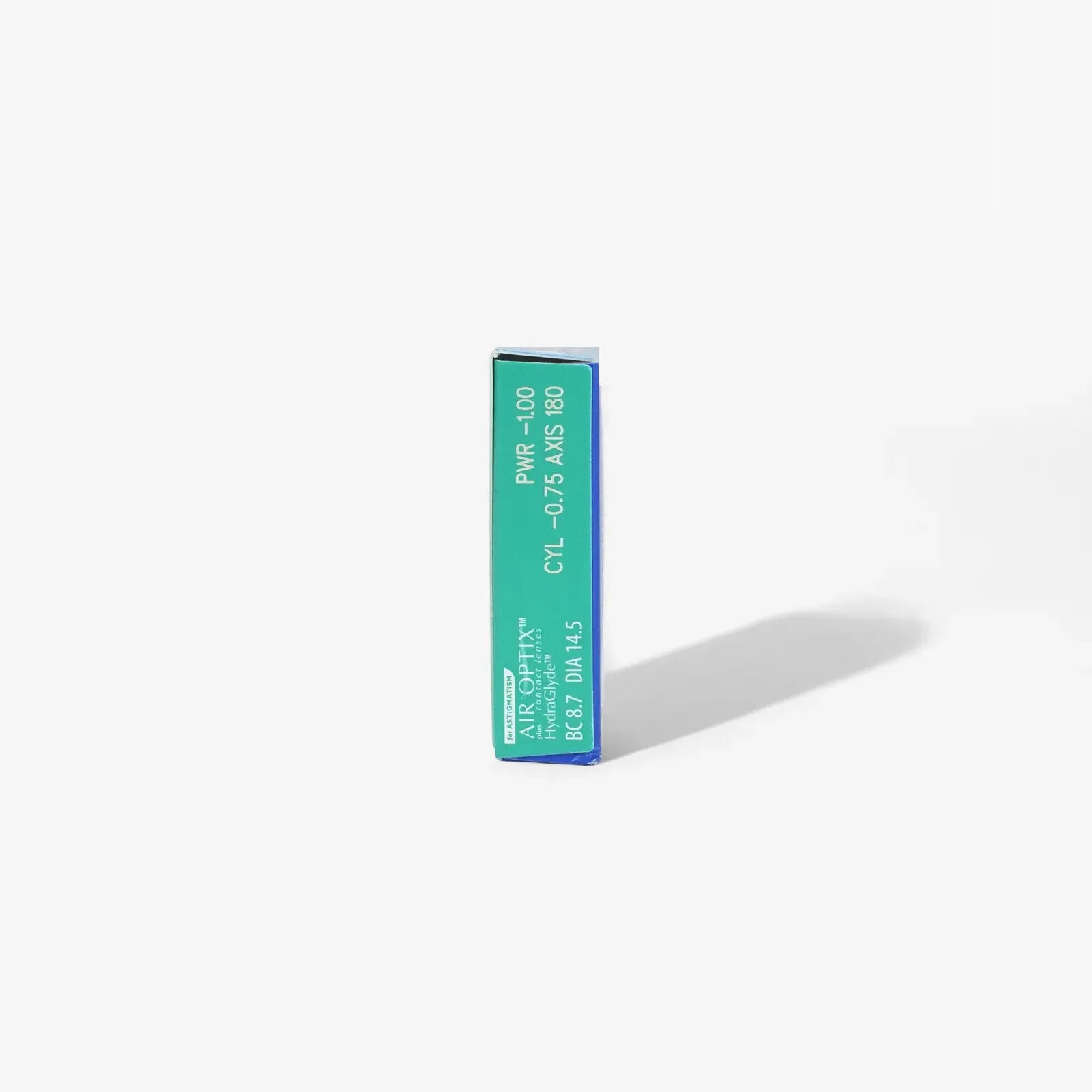 A green and blue Air Optix Hydraglyde For Astig 6Pk box from Air Optix stands upright on a white background with a shadow to the right—ideal for anyone seeking comfortable contact lenses.