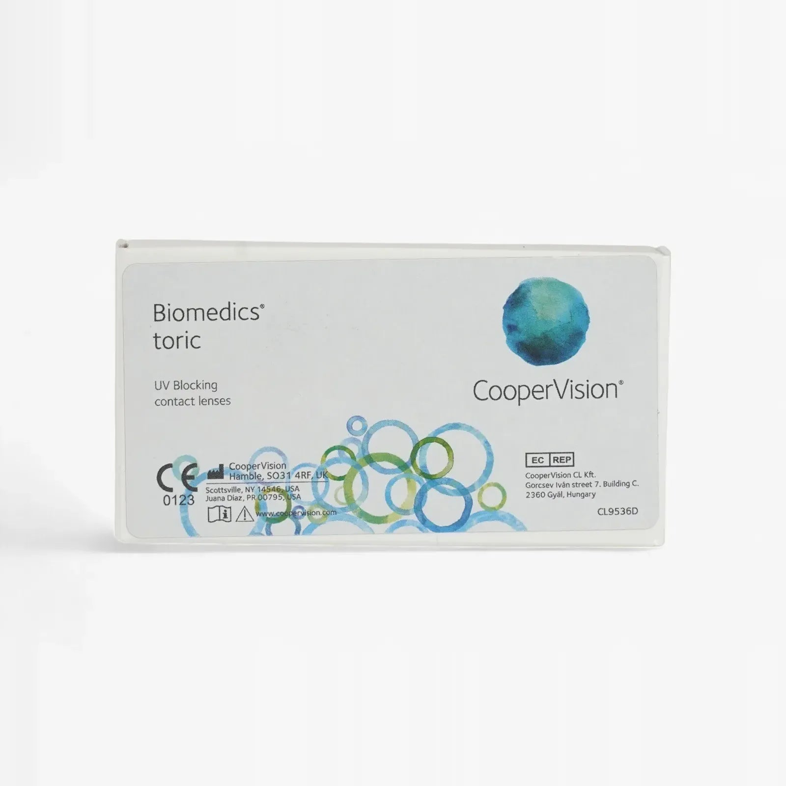 A white box of Biomedics Toric - 6 Pack contact lenses by Biomedics, featuring blue and green circular designs, UV blocking text, and labeled with product and company details.