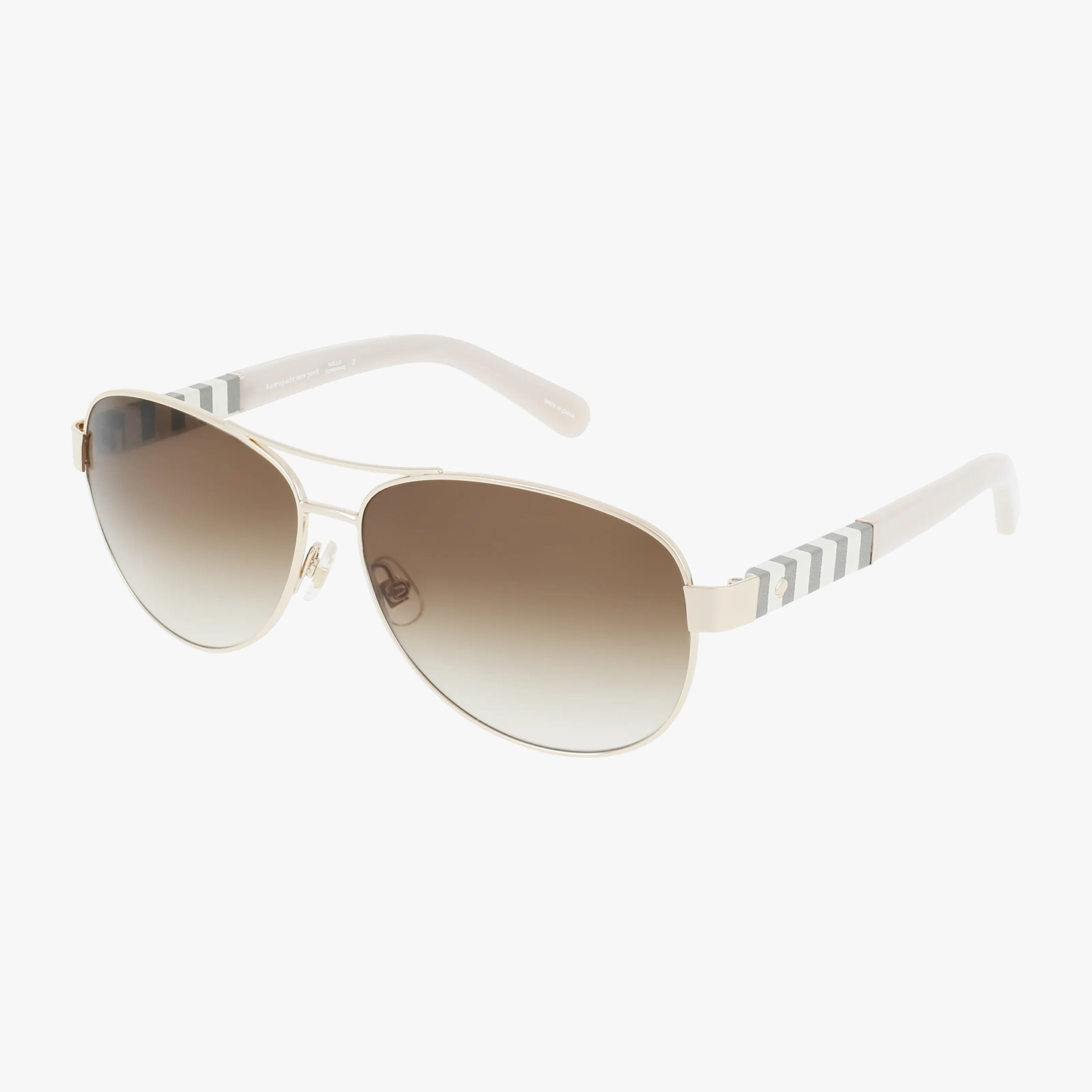 The Kate Spade DALIA/S US aviator sunglasses feature gold frames, brown gradient lenses, and white arms with gray chevron stripes near the hinges—ideal for your next outdoor adventure. Shown on a white background.