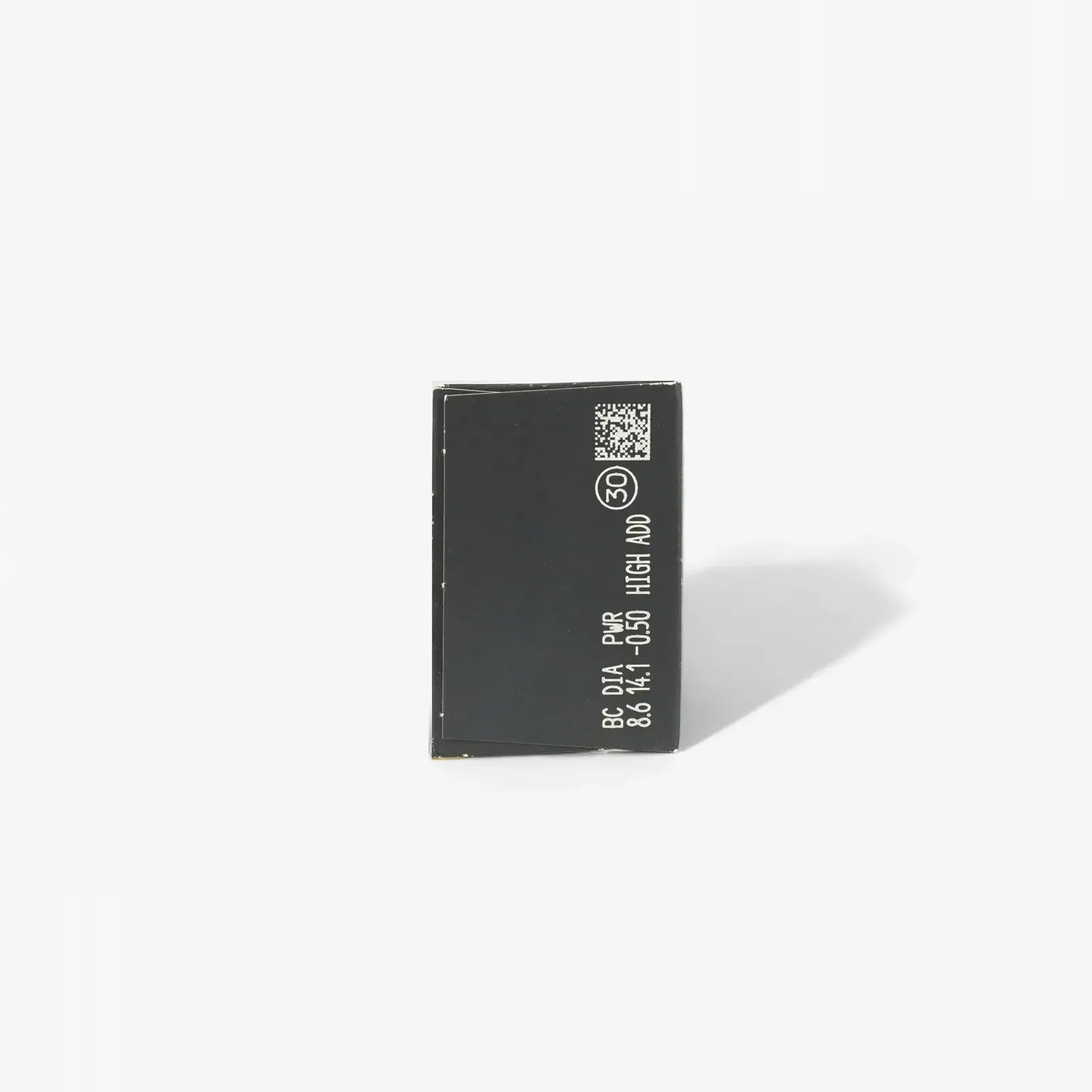 A small, rectangular black chip with white text and symbols stands upright on a plain white background—evoking the clarity and precision of Clariti 1Day Multifocal 30-Pk contact lenses by Clariti.