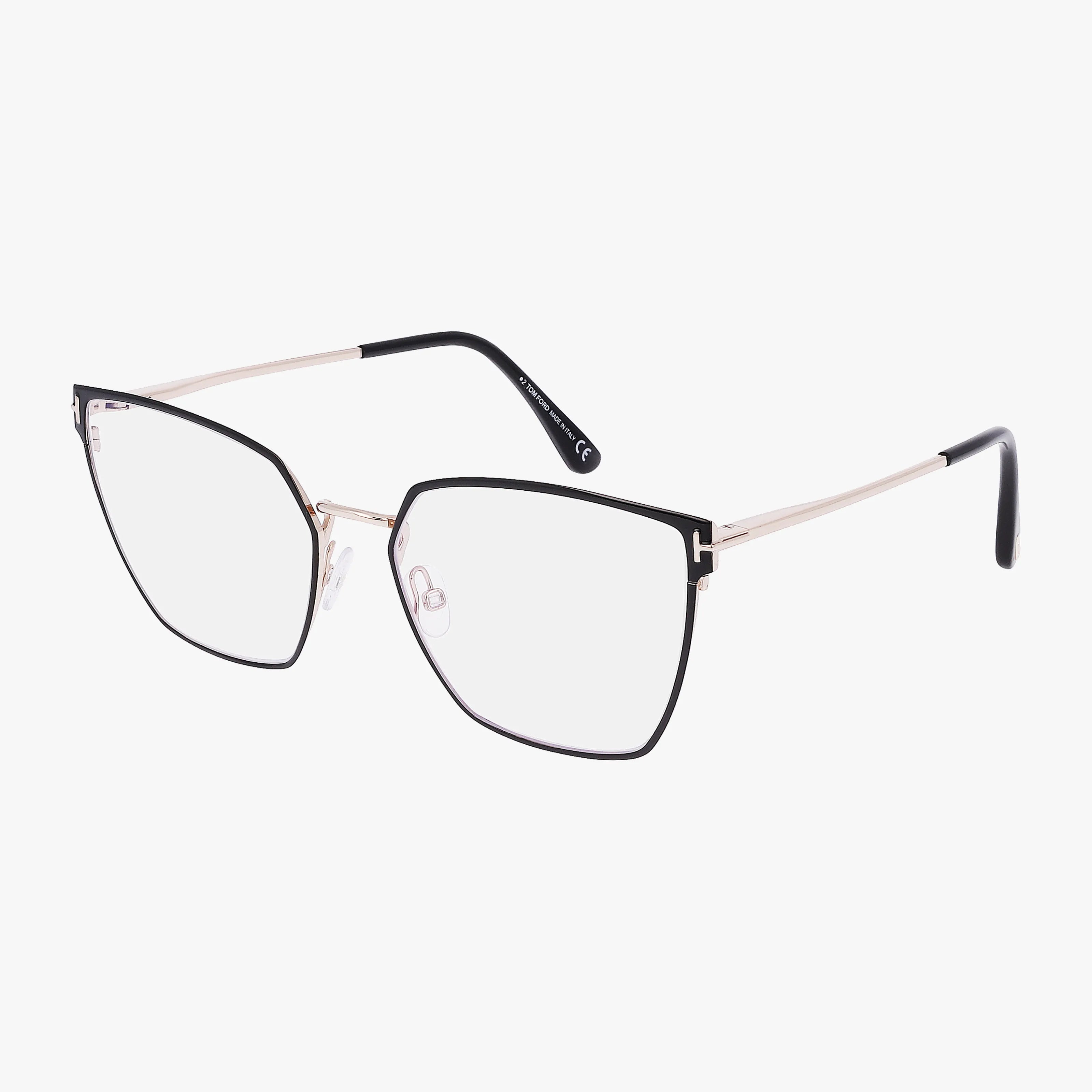 The Tom Ford FT5574-B eyeglasses feature large, geometric black frames, gold metal arms, and clear lenses for a bold look and functional design, displayed against a white background.