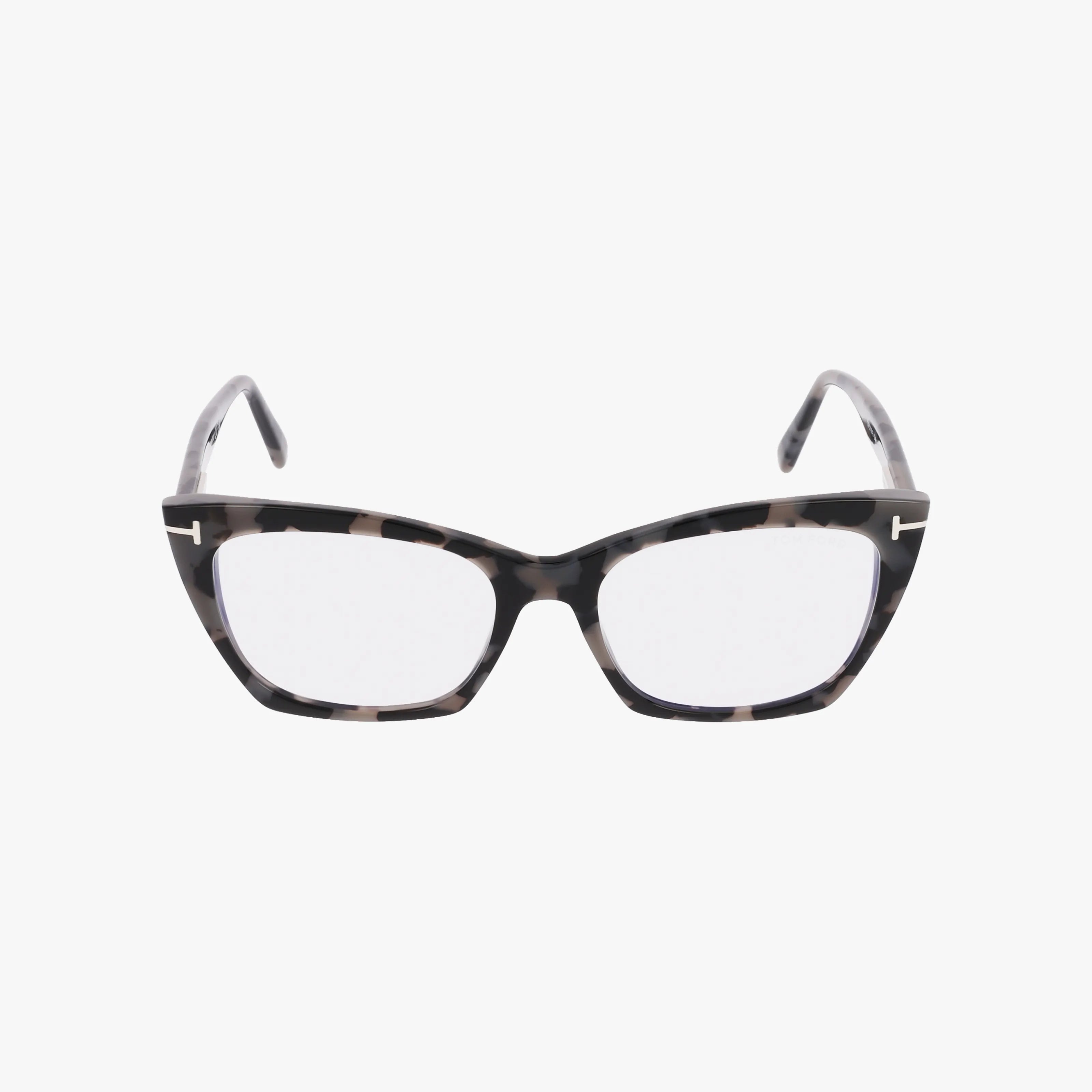 Tom Ford FT5709-B cat-eye eyeglasses feature a chic dark tortoiseshell frame with clear lenses and metallic accents on the upper corners, displayed on a white background.