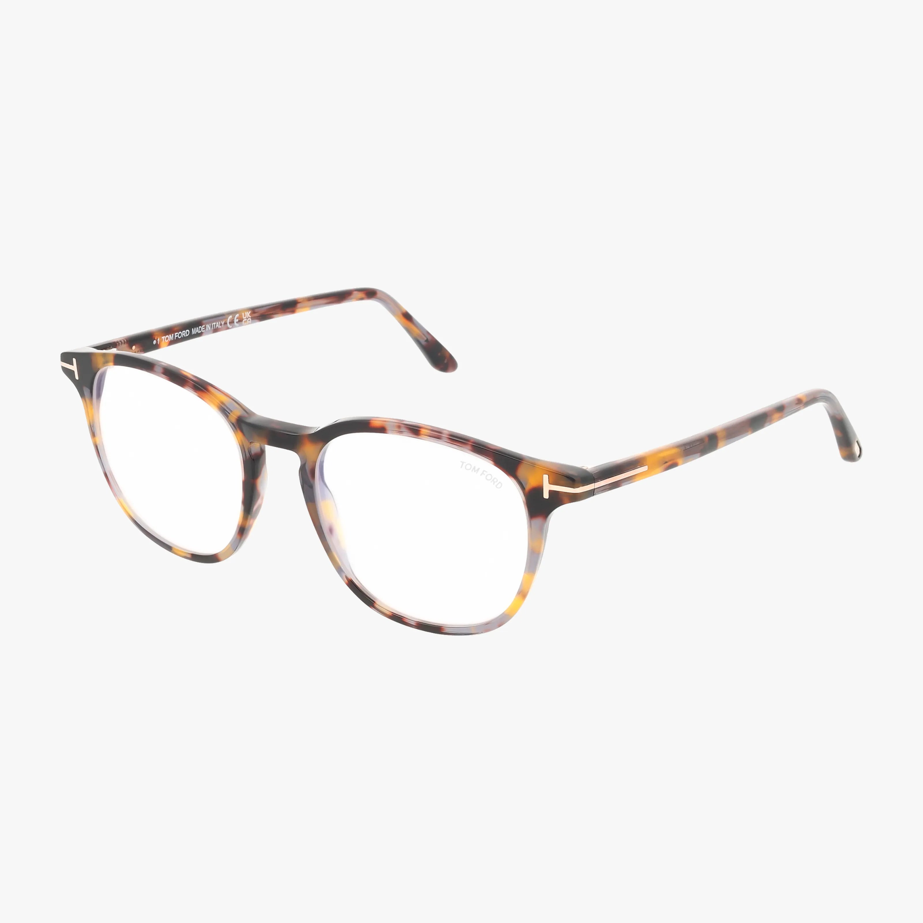 Tom Ford FT5832-B eyeglasses feature brown tortoiseshell round lenses and thin, stylish frames with metal-accented temples for an elegant touch. Shown on a white background and compatible with transitional lenses for versatile wear.