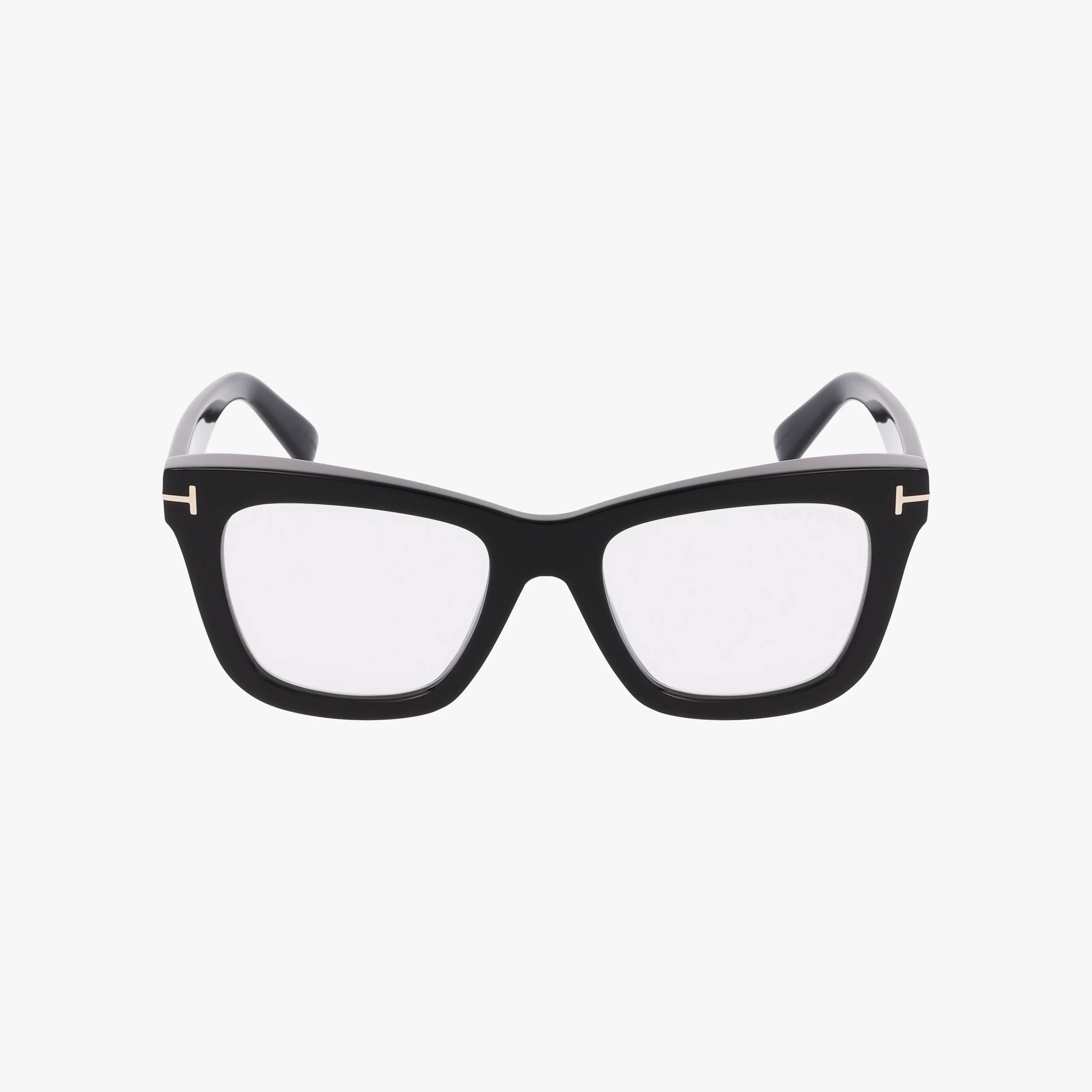 The Tom Ford FT5881-B features black square, thick yet lightweight frames with clear lenses and signature gold “T” accents on the hinges, shown against a white background.