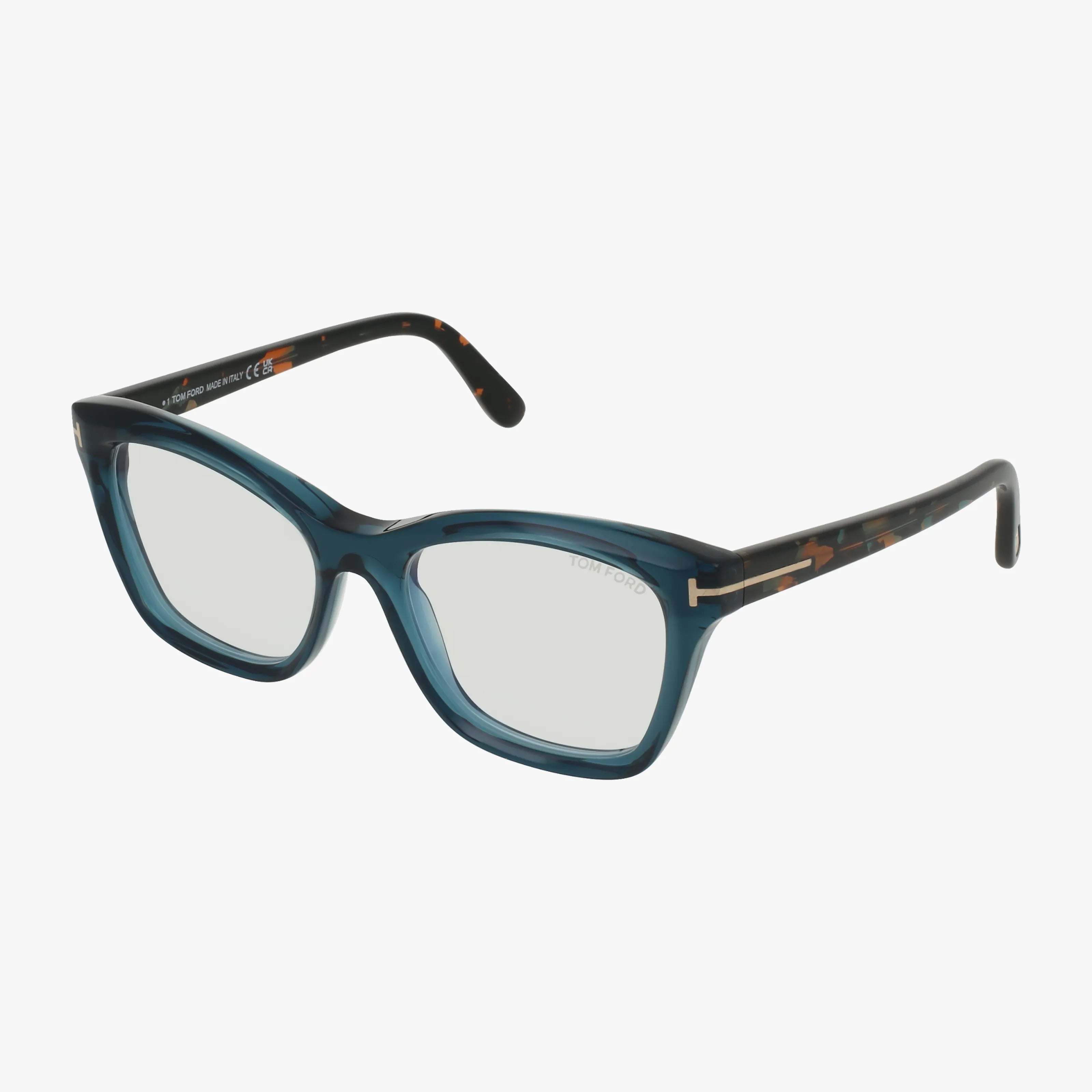 The Tom Ford FT5909-B features blue rectangular acetate frames with clear lenses and dark tortoiseshell-patterned arms, shown on a white background—a modern designer style inspired by classic Tom Ford eyewear.