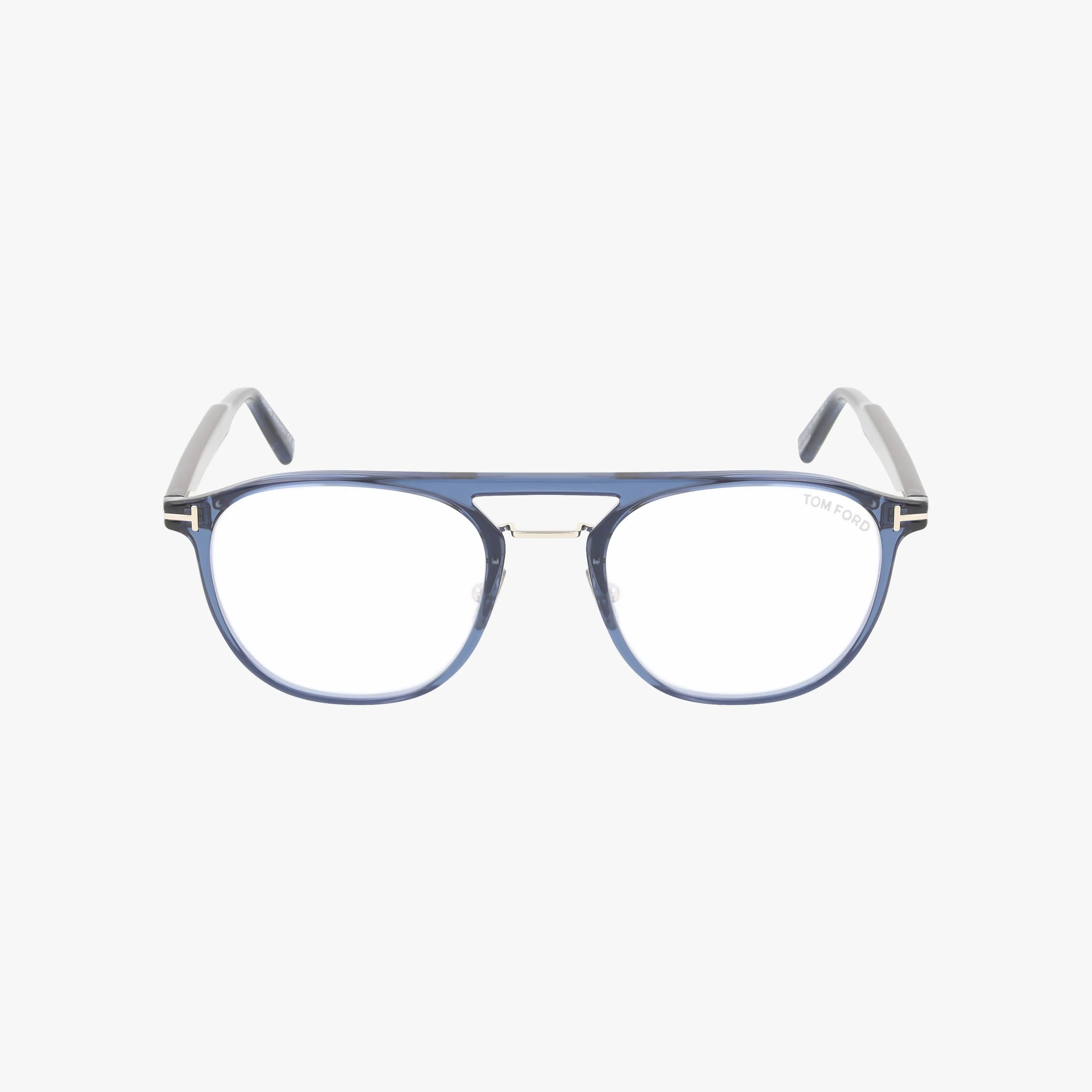 The Tom Ford FT5982-B eyeglasses feature a blue and clear rounded rectangular frame, chic metal bridge detail, and the TOM FORD logo on the right lens. Transparent temple ends add elegance. Shown on a white background.