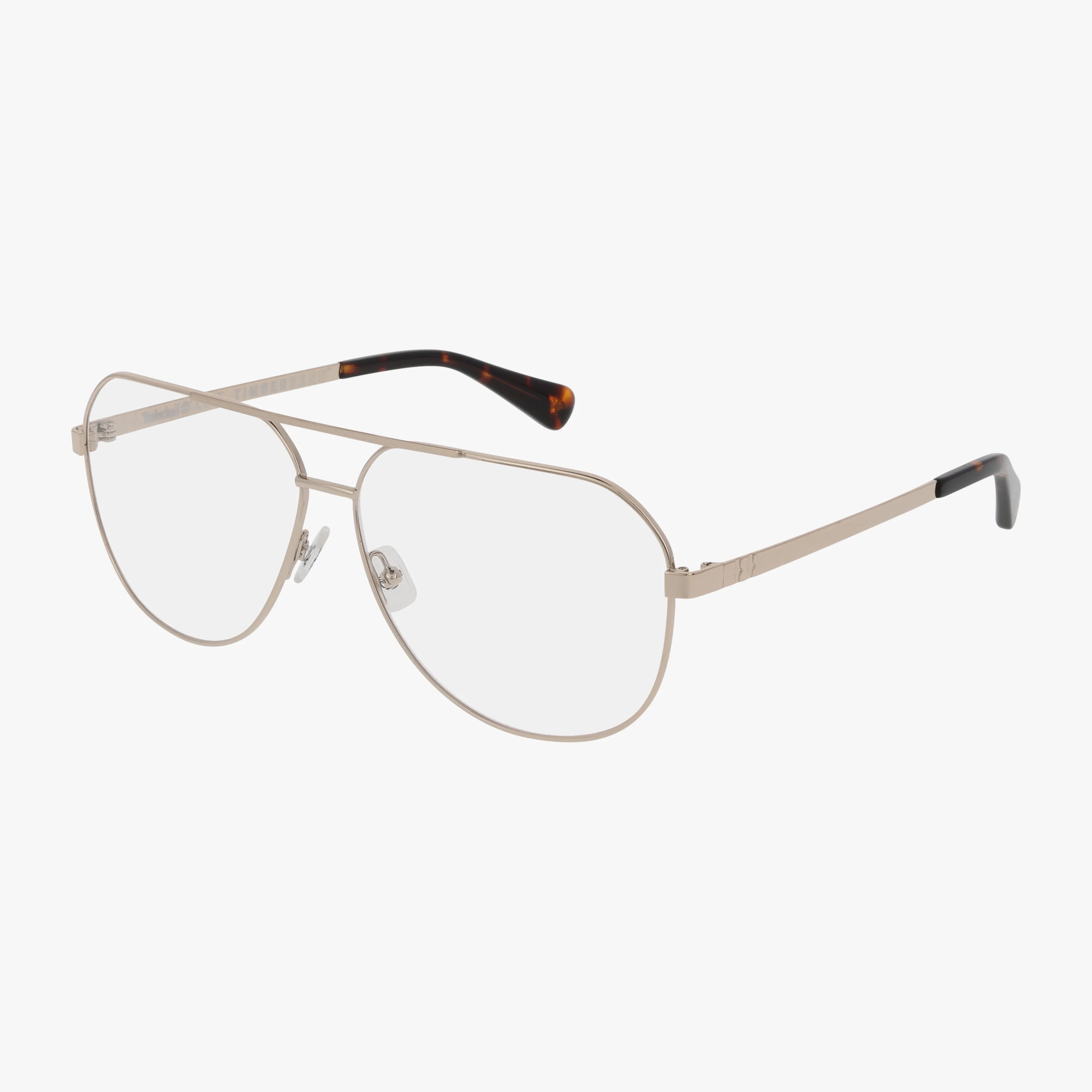 Timberland TB50057 gold metal aviator eyeglasses with clear lenses feature a modern frame, adjustable nose pads, and slim temples with dark tortoiseshell tips, shown on a white background.