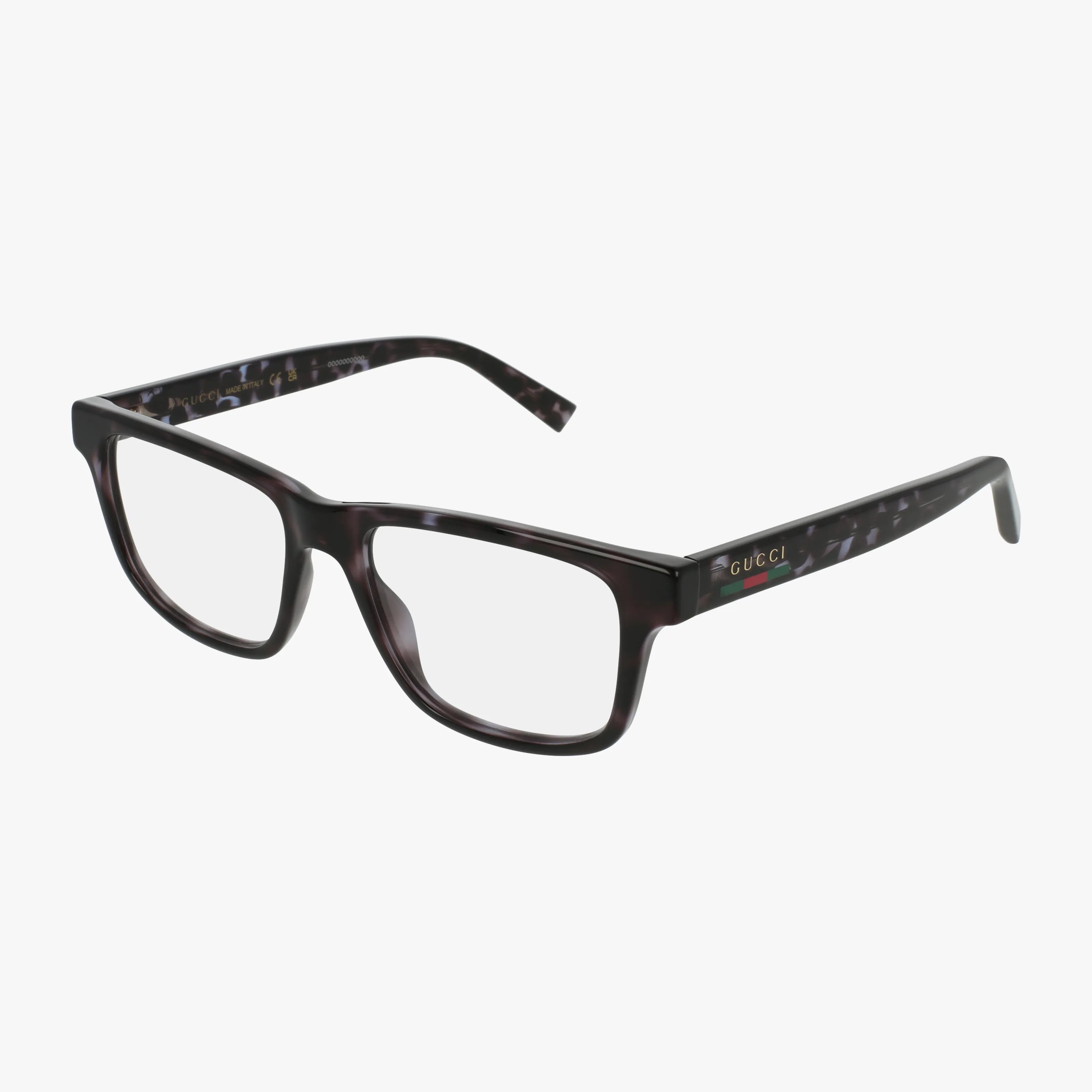 The Gucci 1987O eyeglasses feature a rectangular, tortoise frame with clear blue light lenses and gold Gucci logo on the temples, set against a white background.